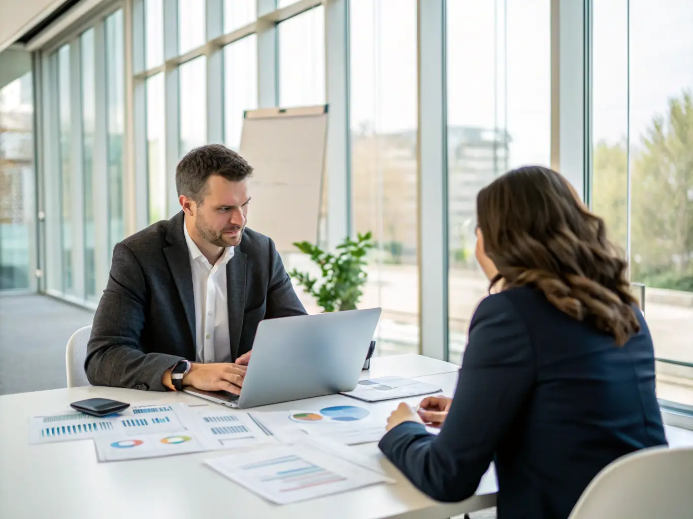 A professional IT consultant advising a client in a modern office setting, emphasizing problem-solving and strategic technology implementation.